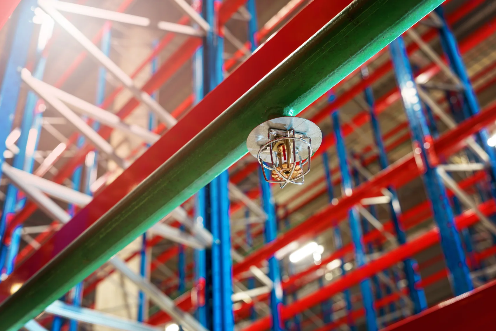 Automatic fire sprinkler head installed in a large warehouse